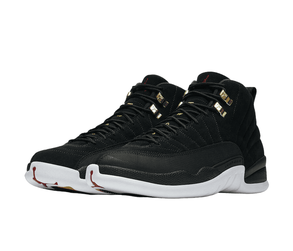 A pair of AJ12 “Reverse Taxi” sneakers in black suede, white soles, black suede mudguards, and gold lace locks.