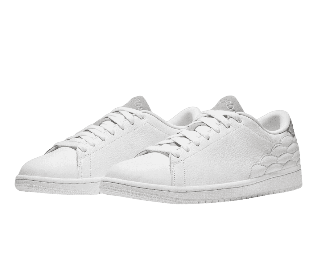 A pair of AJ1 Centre Court “White” sneakers in white leather, a light beige tongue and heel, and a scale design stitched around the heel and midsections.