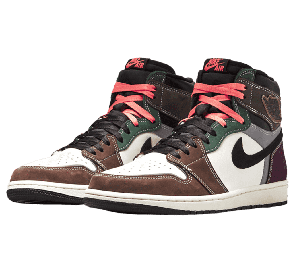 A pair of AJ1 High “Handcrafted” sneakers in white uppers with brown, green, gray suede overlays, a purple heel, black laces, and bright red laces at the top.