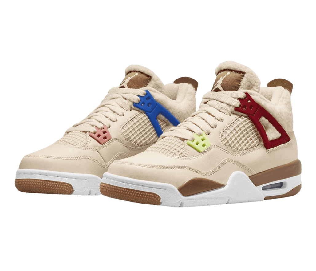 A pair of AJ4 “Where The Wild Things Are” sneakers in tan suede, green, red, and blue lace cages, white midsoles, brown detailing, a wool collar, and fleece lining.