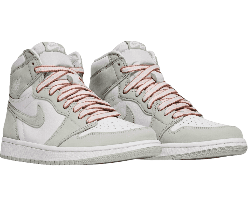 A pair of AJ1 High OG “Seafoam” sneakers in white with light green gray overlays and salmon laces with dark salmon edges.