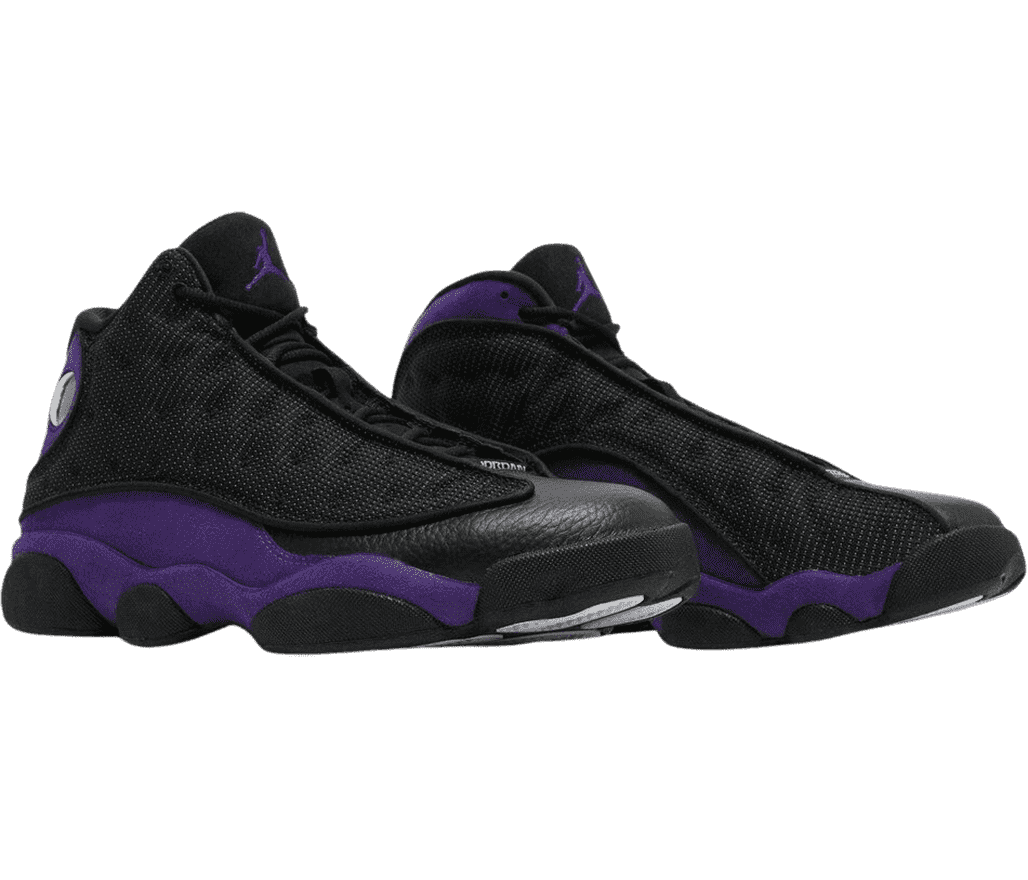 A pair of AJ13 Retro sneakers with purple quarters, black leather toeboxes, black fabric vamps with circular embroidery, black outsoles, and a purple Jordan logo on the tongue.