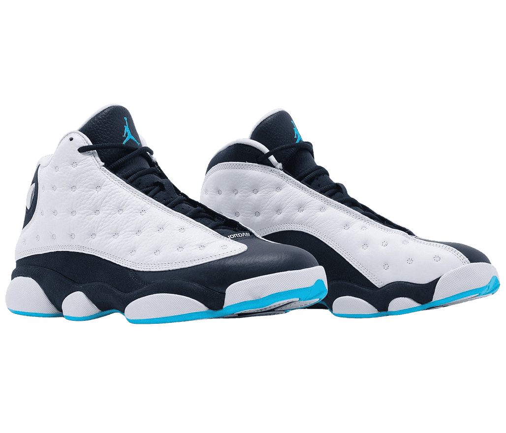 A pair of AJ13 Retro sneakers with black quarters and toeboxes, white leather vamps with circular embroidery, black laces, turquoise outsoles, and a turquoise Jordan logo on the tongue.