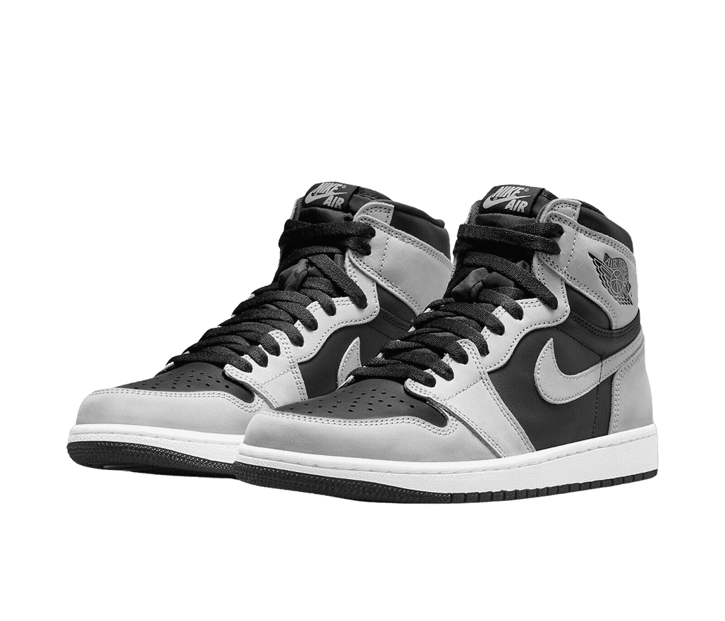 A pair AJ1 “Shadow 2.0” sneakers with black quarters, toeboxes, and laces, smoky gray overlays, white midsoles, and black outsoles.