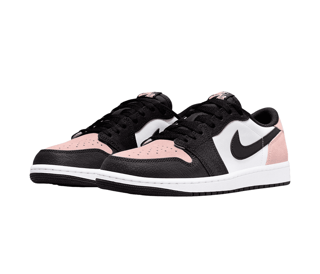 A pair of AJ1 Low “Bleached Coral” sneakers with white quarters and midsoles, light pink toeboxes and heels, and black overlays and outsoles.