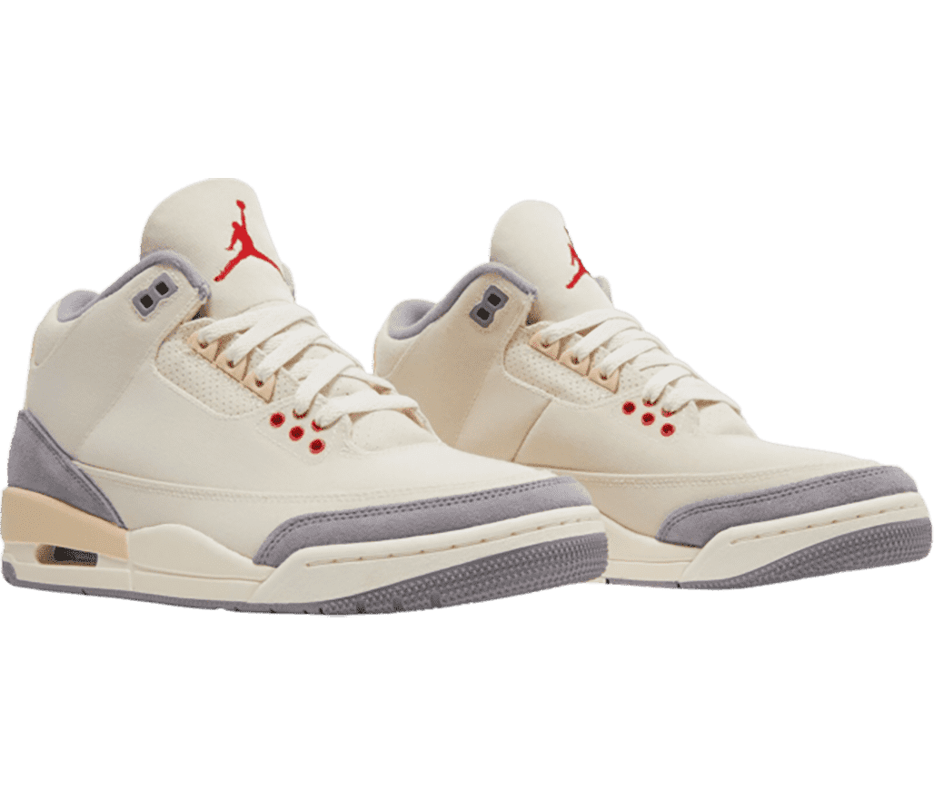 A cream pair of AJ3 Retro “Muslin” sneakers with gray heels, tips, and outsoles, red lower eyelets and Jordan logo on the tongue, and a darker shade of cream at the heel of the midsole and the heel counter. 