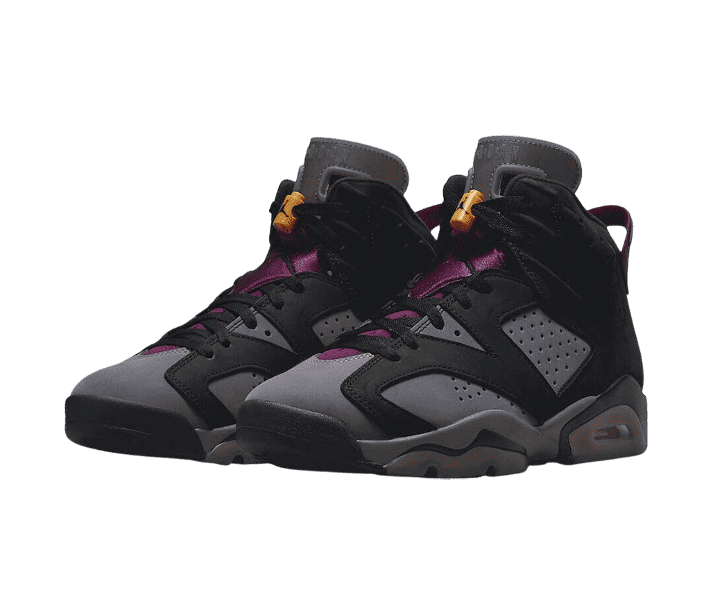 A black and gray pair of AJ6 “Bordeaux” sneakers in suede. They have purple tongues, black laces, and orange lace locks.