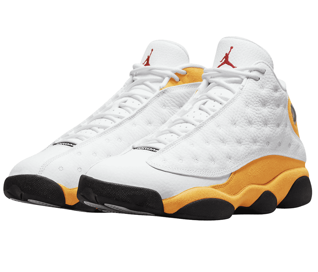 A pair of AJ13 “Del Sol” sneakers with golden yellow quarters, white tongue and toeboxes, white vamps with circular embroidery, black outsoles, and a red Jordan logo.
