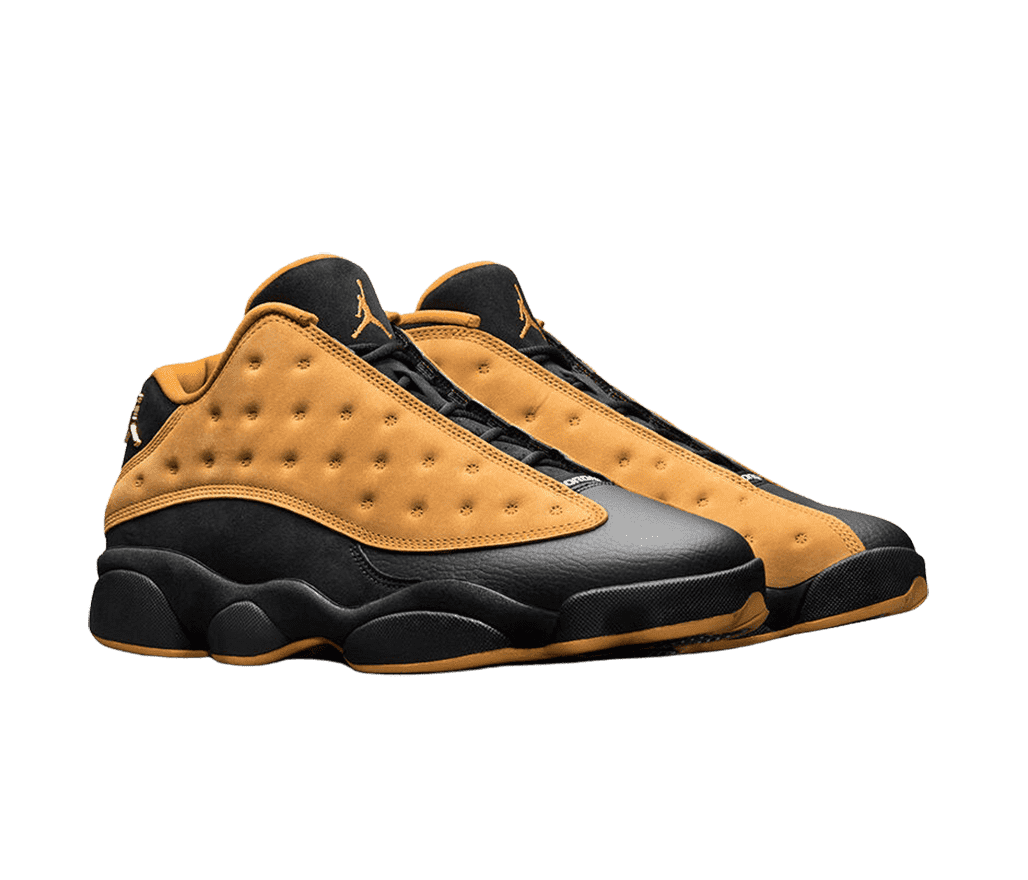 A pair of AJ13 “Chutney” sneakers with black leather toeboxes, and sand gold suede vamps with polka-dotted embroidery.