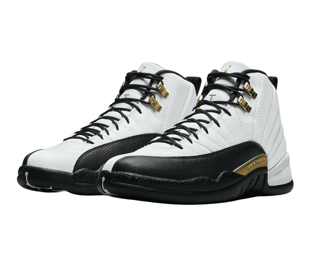 A pair of AJ12 “Royalty” sneakers in white leather, black soles and mudguards with a gold accent in the middle of the lateral side, and gold lace locks.