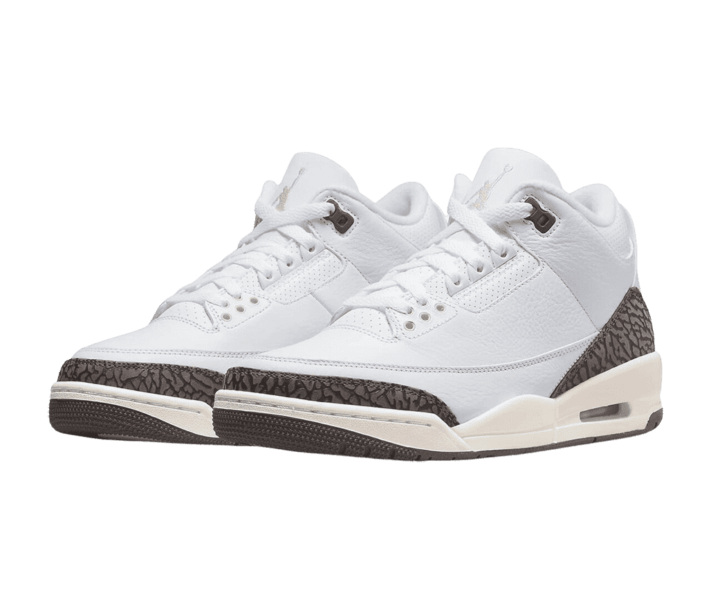 A pair of white AJ3 “Mocha” sneakers with brownish gray elephant print tips and heels, cream midsoles, dark brown outsoles, pink accents at the heels, and a cream Jordan logo.