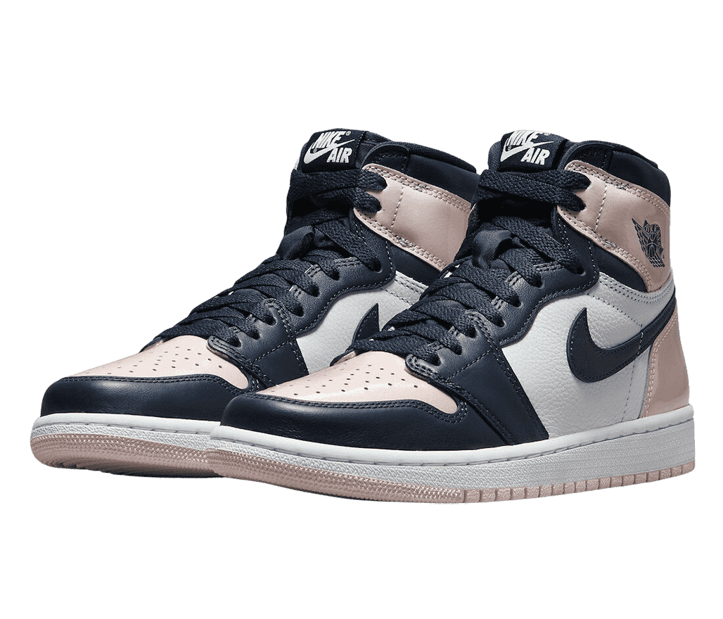 A pair of AJ1 “Atmosphere” High sneakers with white quarters, pink patent leather toeboxes and heels, and dark anvy patent leather tips, vamps, and collars.