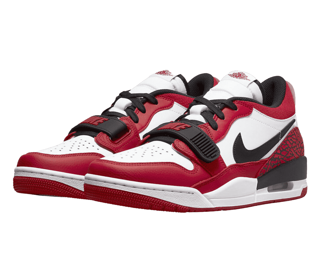 A pair of leather AJ312 “Chicago Red” low sneakers with white quarters, toeboxes, and midsoles, red overlays, black lace straps, laces, and Nike Swoosh, and red and black elephant prints at the heel.