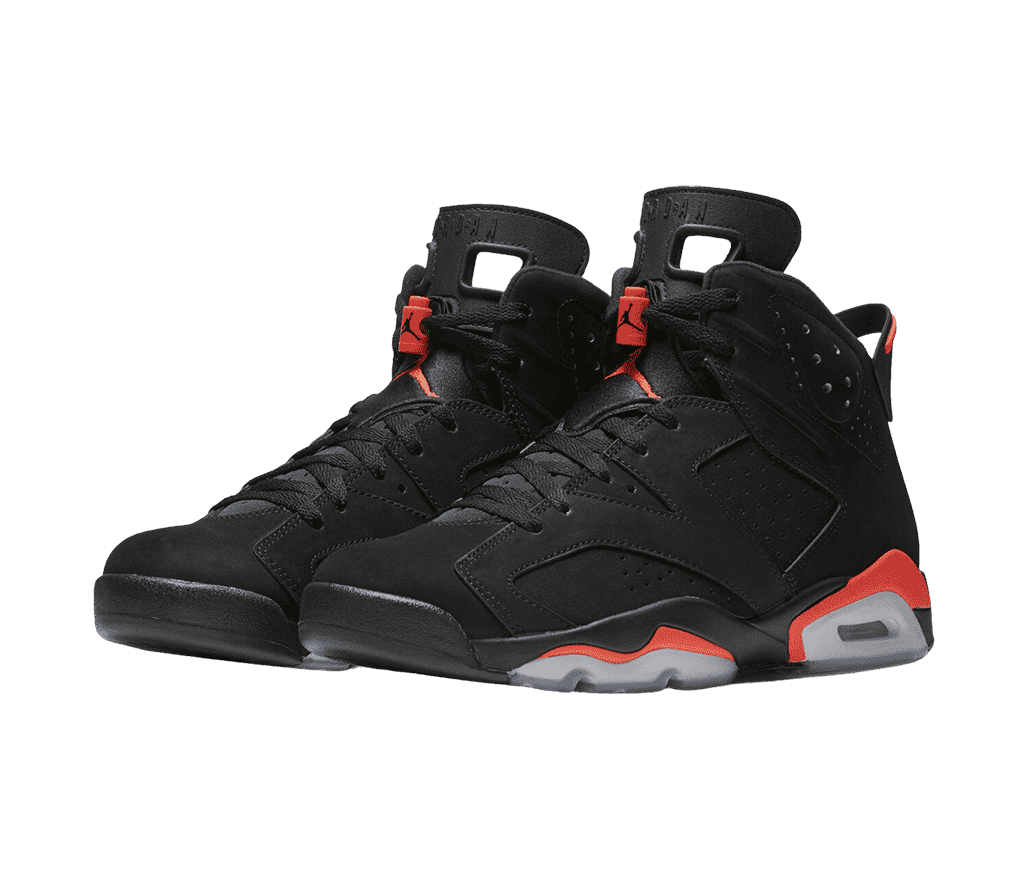 A black suede pair of Jordan 6 “Infrared” sneakers with red lace locks and detailing on the midsoles.