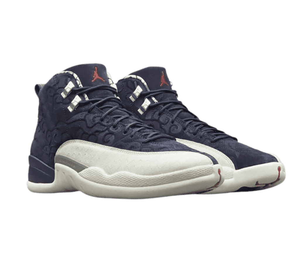 A pair of AJ12 “International Flight” sneakers in navy suede with Kumo cloud patterns, gray lace locks, and white mudguards.