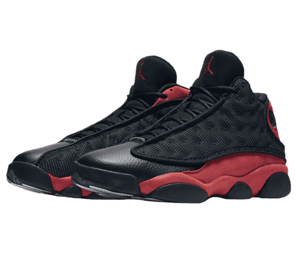 A black pair of AJ13 “Bred 2017” sneakers with red suede quarters, black leather toeboxes, and black fabric vamps with polka-dotted embroidery.