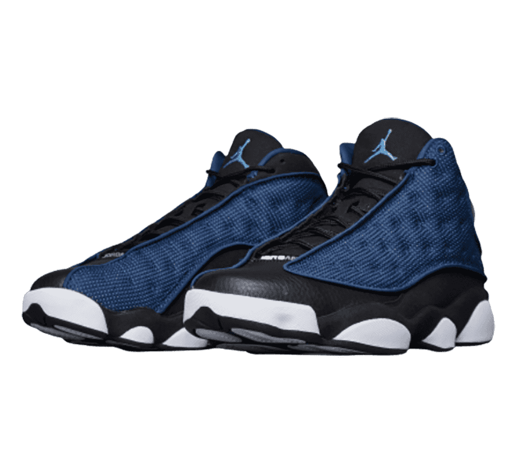 A pair of AJ13 “Brave Blue” sneakers in black leather uppers, white rubber midsoles, and blue fabric vamps with circular embroidery.