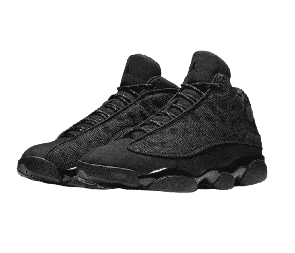 An all-black pair of AJ13 “Black Cat” sneakers with suede upper, fabric vamps with circular embroidery, and rubber soles.