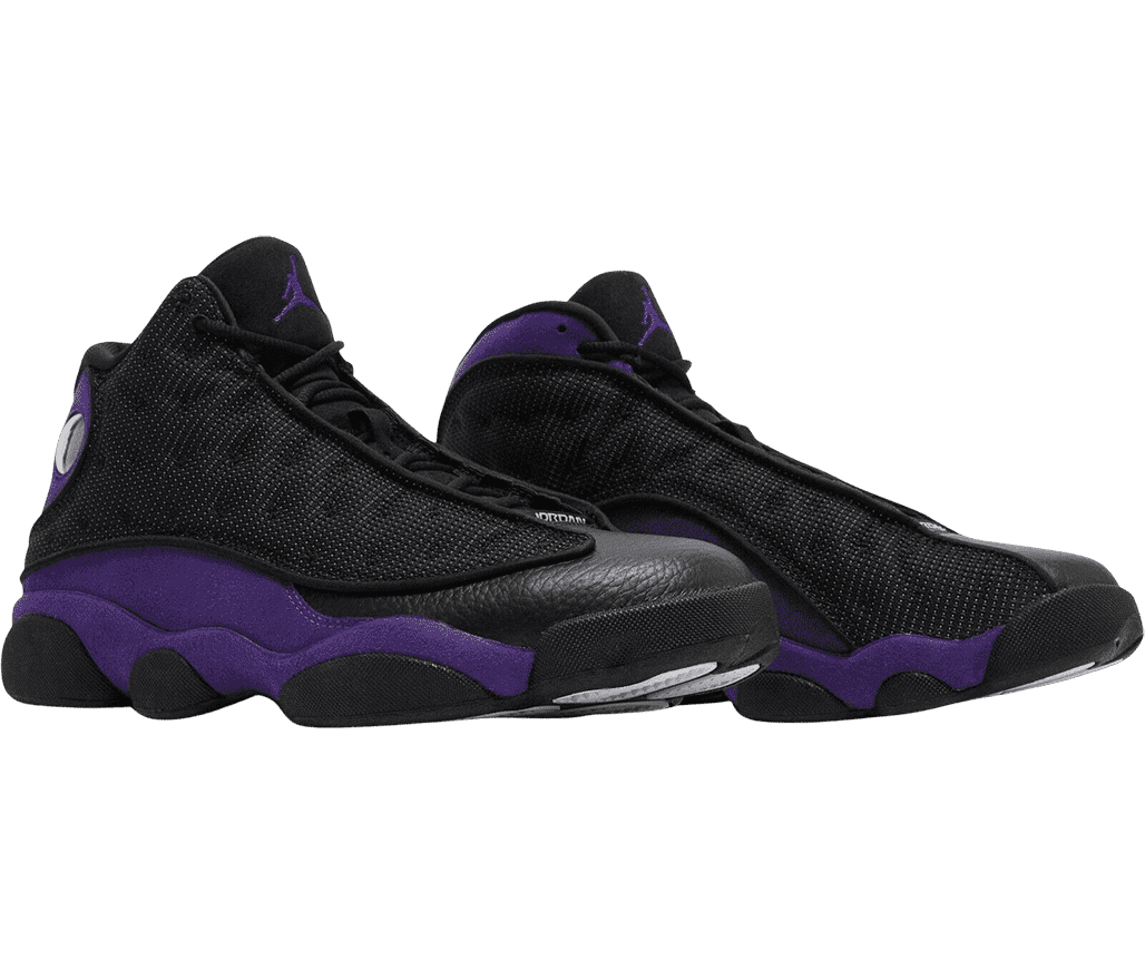 A black pair of AJ13 Retro sneakers with purple suede quarters, black leather toeboxes, and black fabric vamps.