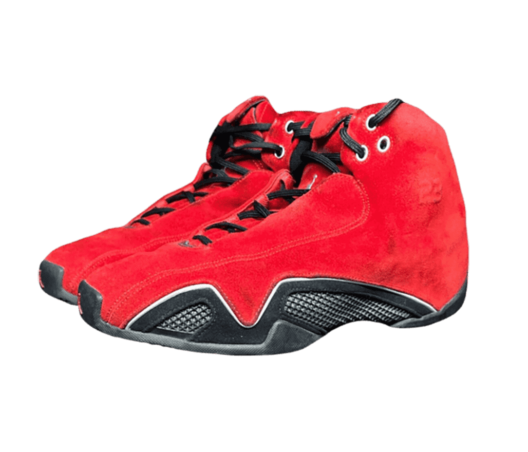 A pair of AJ21 sneakers in red suede uppers with black leather mudguards and metallic silver details.