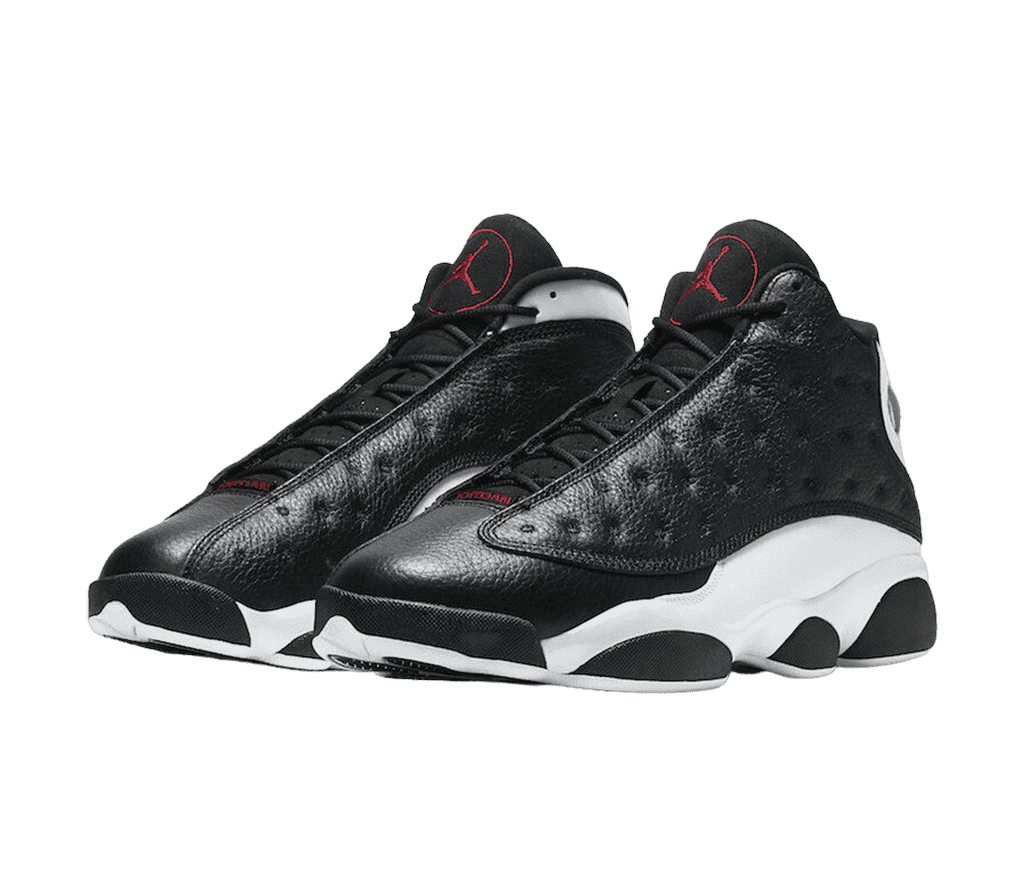 An black leather pair of AJ13 “Reverse He Got Game” sneakers with white midsoles and red Jordan logos enclosed in a red circle.