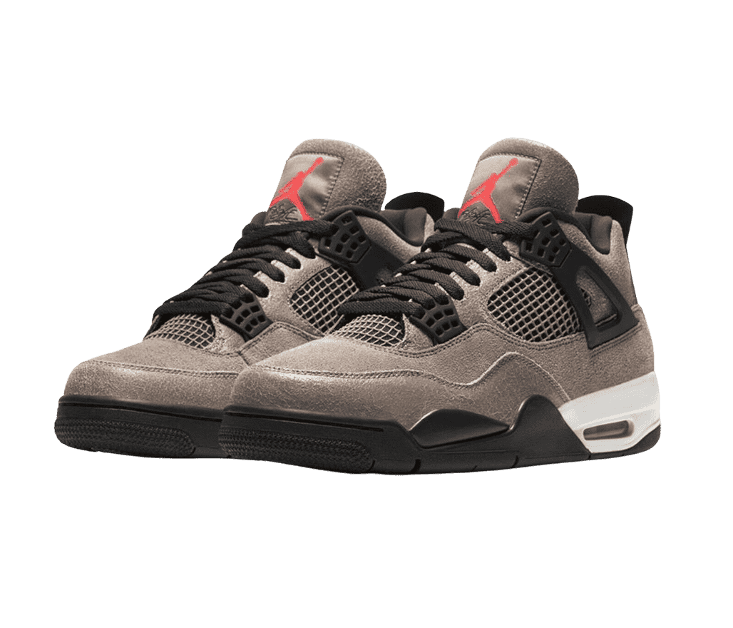 A light brown suede pair of AJ4 “Taupe Haze” sneakers with red logos on the tongues, black laces, lace cages, and soles with a white heel.
