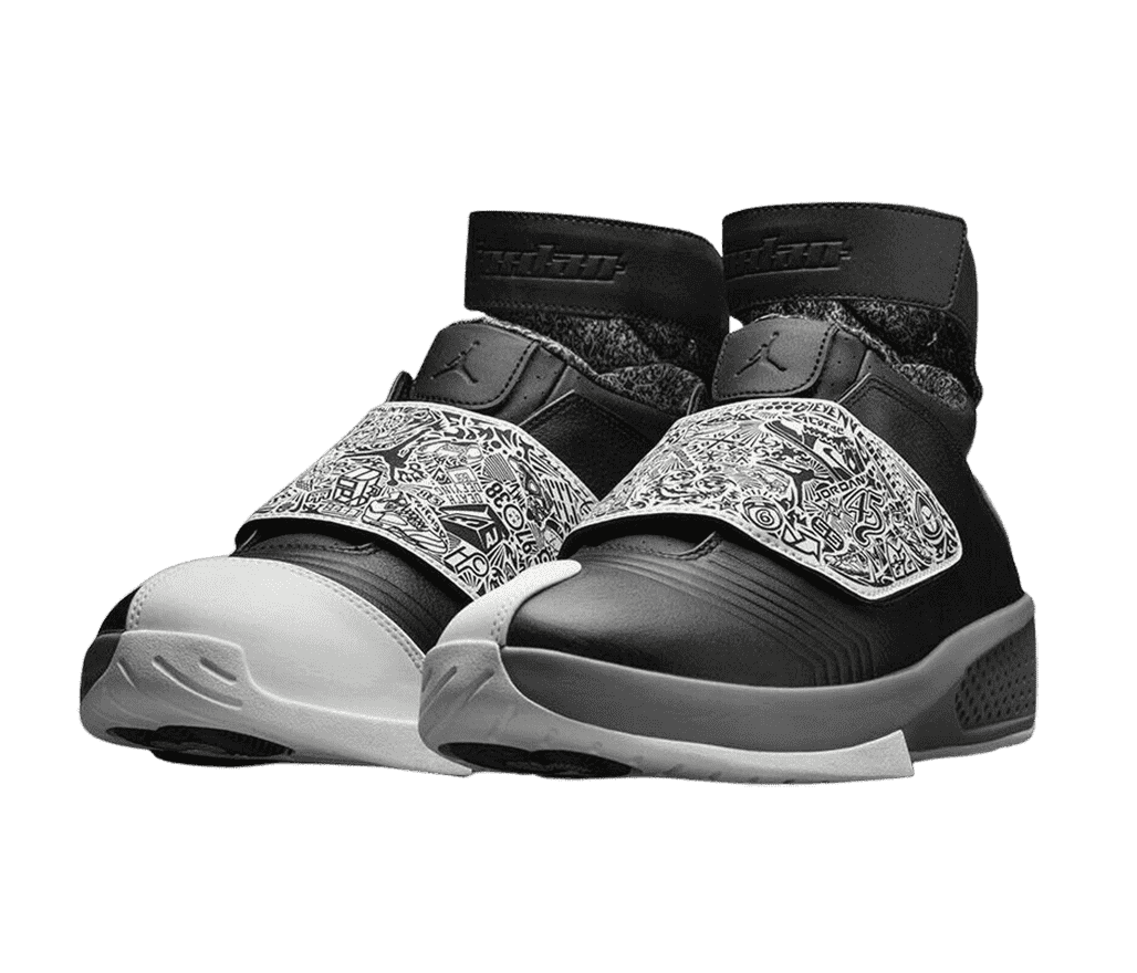 A pair of AJ20 “Oreo” Retro sneakers with a black and white, doodled velcro lace cover, and a light gray mudguard on the inner toe.