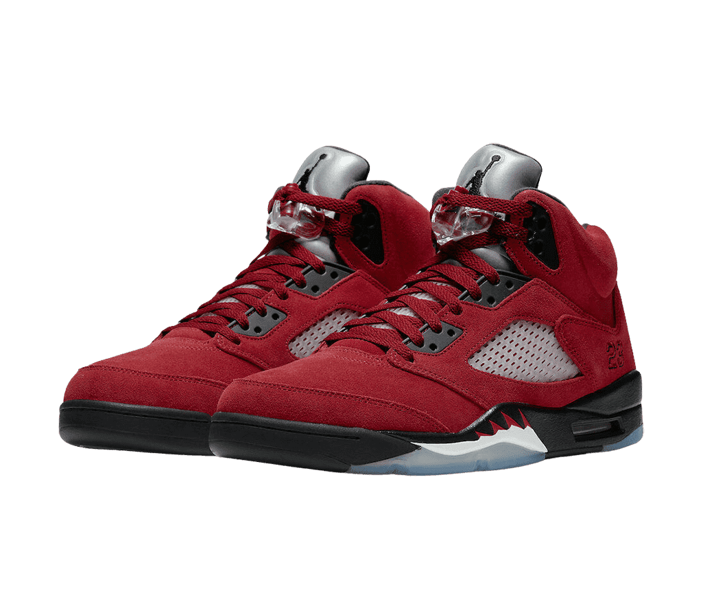 A pair of AJ5 sneakers in a dark red suede, black soles, a clear lace lock, metallic tongues with a black Jordan logo, and translucent perforated plastic in the midsections.