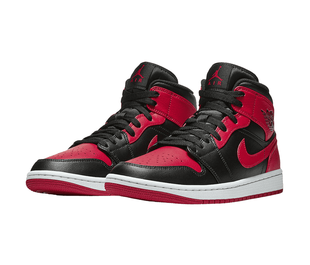 A pair of AJ1 sneakers with black leather tips, quarters, and tongues, white midsoles, and red outsoles, Nike Swoosh marks, and heels.