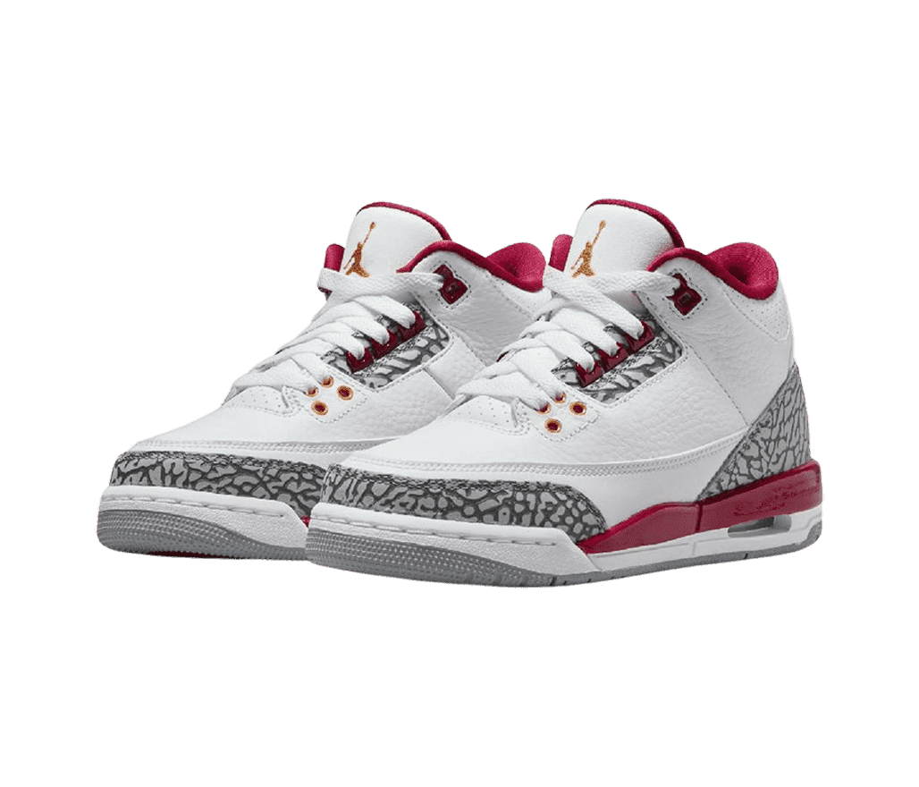 A pair of white AJ3 sneakers with red accents around the sole and collar, a gray outsole, and black and gray elephant print tips and heels.