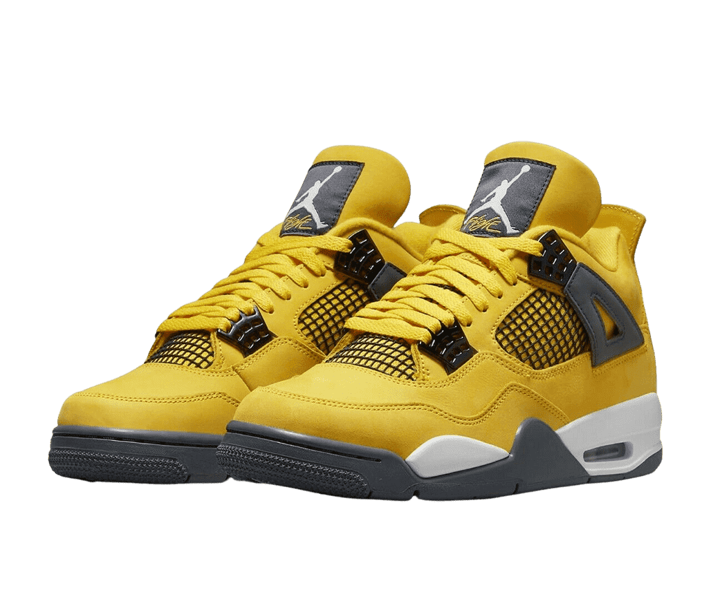 A pair of AJ4 “Lightning” Retro sneakers in a golden yellow suede, black netted sections on the sides and lower tongue, black lace cages, and dark gray rubber outsoles.