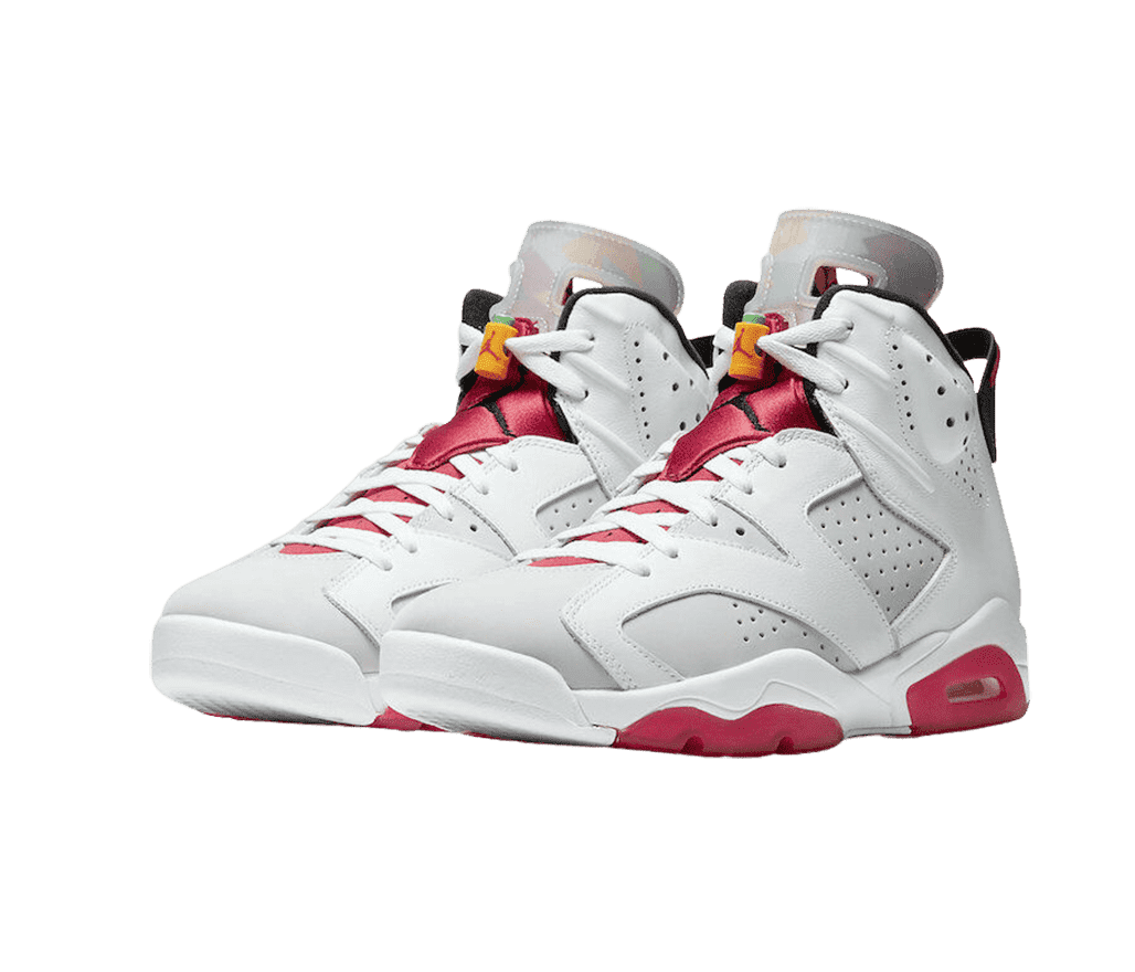 A suede pair of AJ6 “Hare” sneakers with red accents on the soles and tongues, light gray overlays on darker gray uppers, and orange and green lace locks with red Jumpman logos.