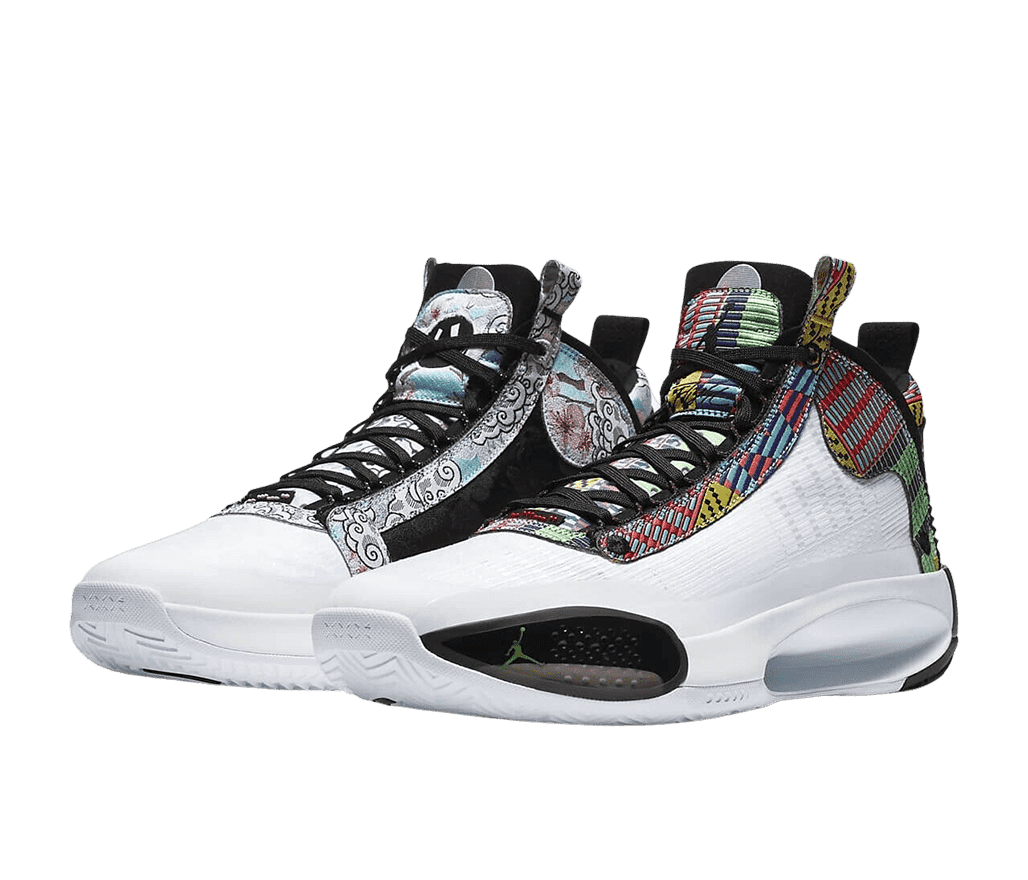 A pair of AJ34 “Heritage” sneakers with multicolored Japanese graphics on the tongues, vamps, collars, and heels, white soles, toeboxes, and quarters and black outer toes.