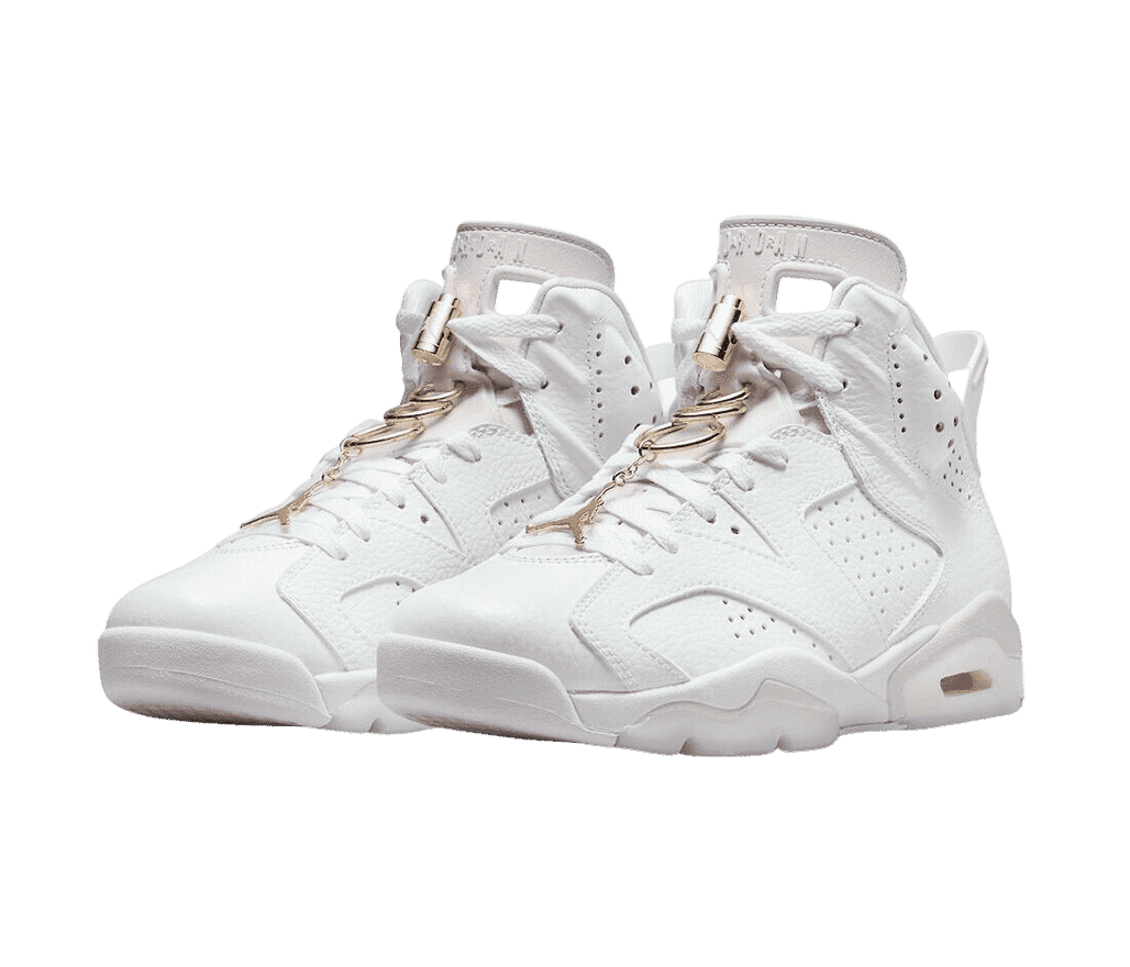 A white pair of AJ6 “Gold Hoops” sneakers with gold metal lace locks and hoops on the tongue with the Jumpman logo hanging off the bottom hoop.