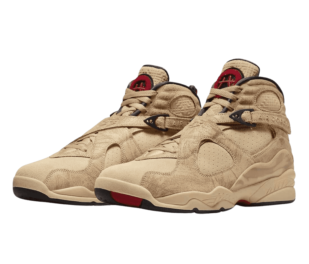 A pair of Rui Hachimura x AJ8 sneakers in sandy shades of short and long suede, dark red accents, and lace straps with the Air Jordan logotype debossed on them.