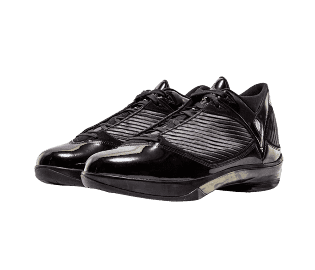 A black pair AJ 2009 “S23” sneakers in patent leather uppers, rubber soles, and ribbed midsections and heels.