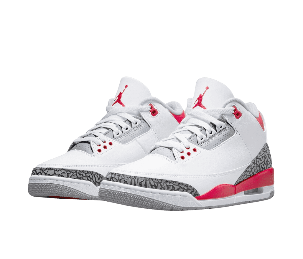 A pair of white AJ3 sneakers with red accents around the sole and collar, a gray outsole, and dark gray elephant print tips and heels.
