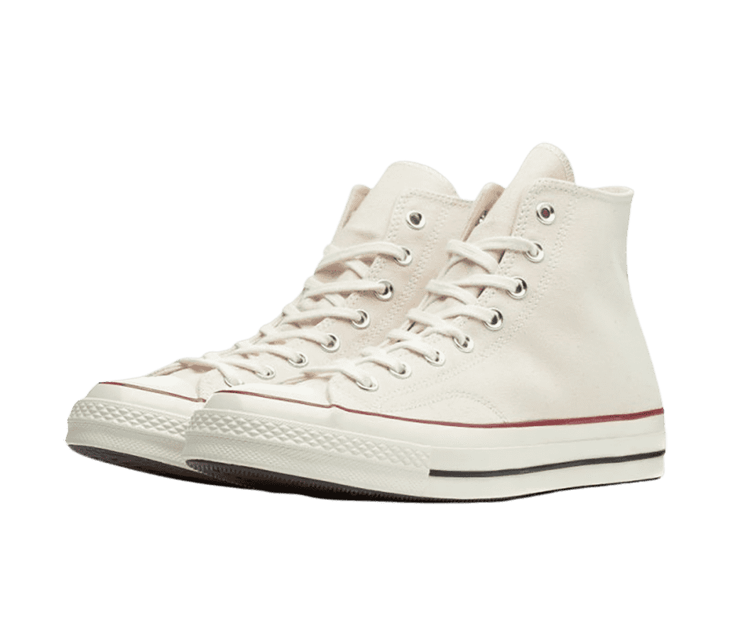 A pair of Converse x Joshua Vides Chuck 70 Hi sneakers in creamy white fabric and red and blue outlines along the soles.