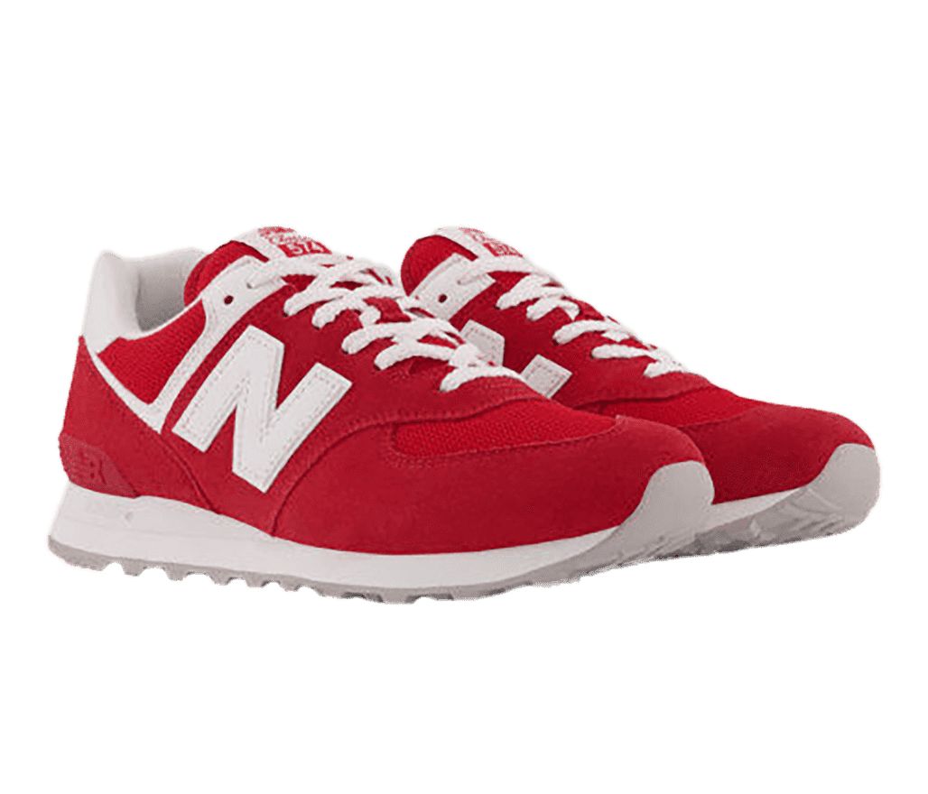 A pair of New Balance 574 sneakers in red suede, white soles, laces, and “N” logo-letter on the sides.