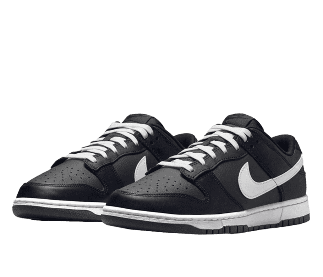 A pair of black and white Nike Dunk Low sneakers with white shoelaces.
