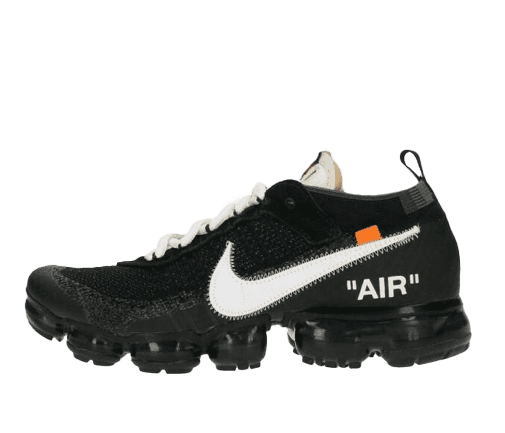 A side shot of a black Nike cleat with white shoelaces. The side of the shoe features a white oversized Nike logo, with a small orange tab above it. The word 'AIR' is written in white, just below the logo.