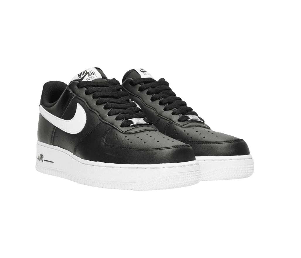 A black leather pair of Nike AF1 Low '07 sneakers with white soles, Swoosh overlays, and tags on the tongue.