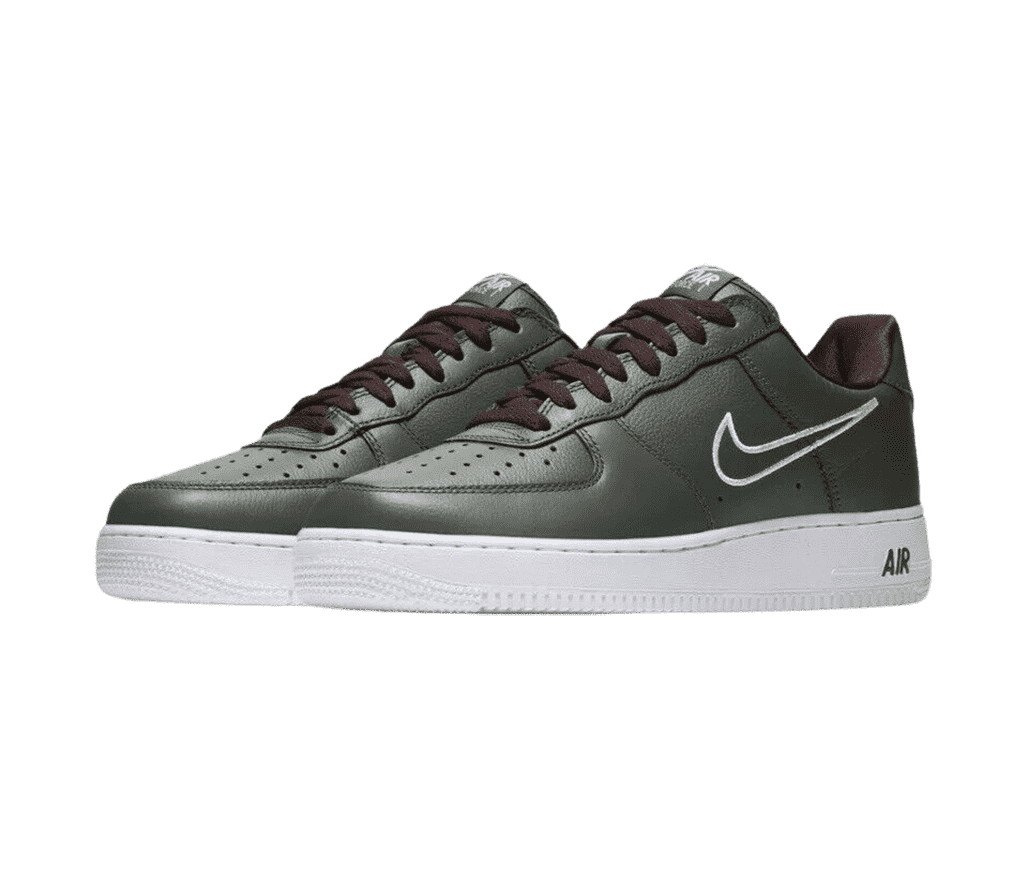 A pair of AF1 Low “Hong Kong” sneakers in a dark olive upper, brown laces and lining, white soles, and a small white outline of the Nike Swoosh.