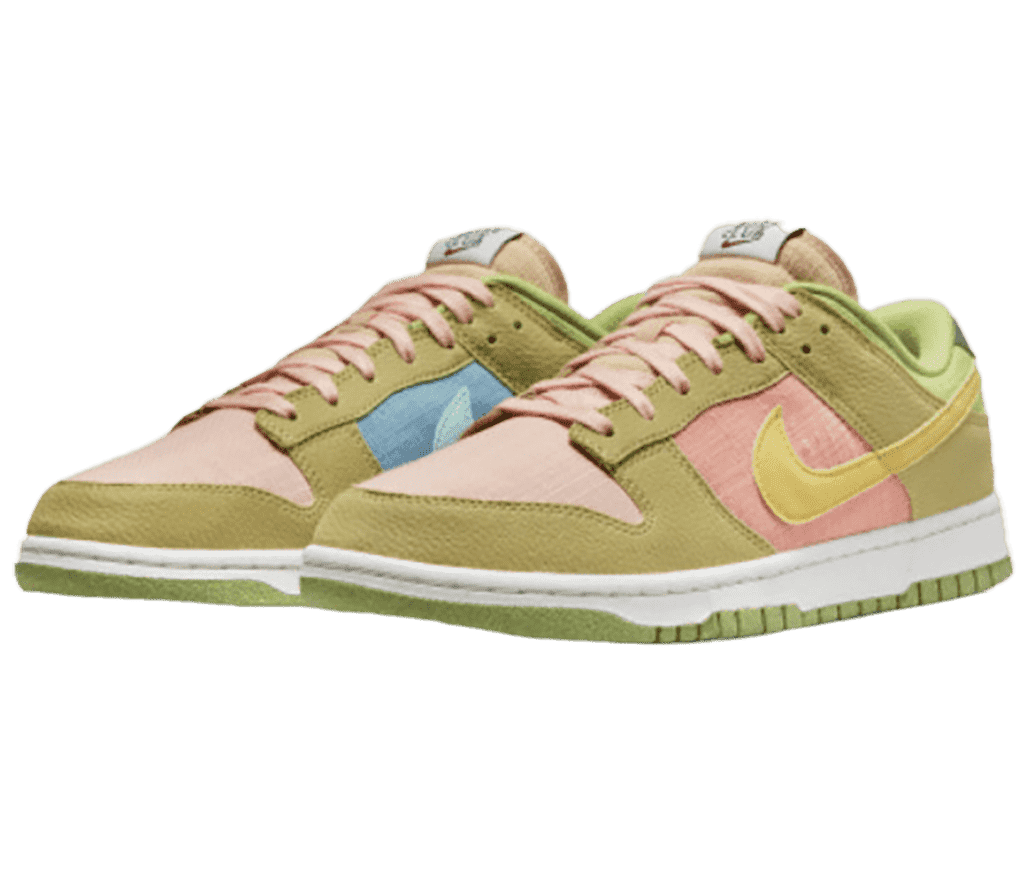 A pair of Nike Dunk Low “Sun Club” sneakers in pink and blue fabrics, light olive suede, and white midsoles.