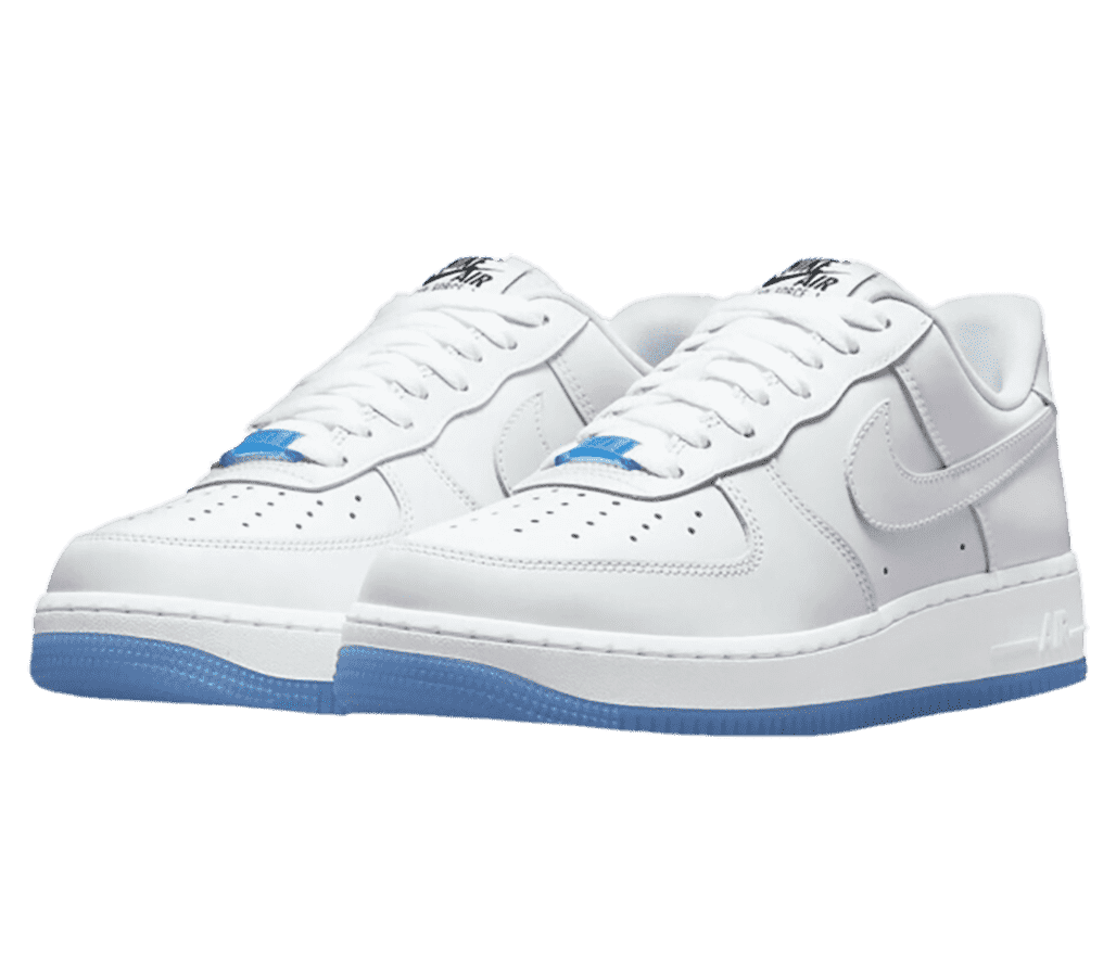 A white pair of Nike AF1 Low “UV Reactive” sneakers with blue outsoles and pinkish and bluish hues on the iridiscent tips and heels.