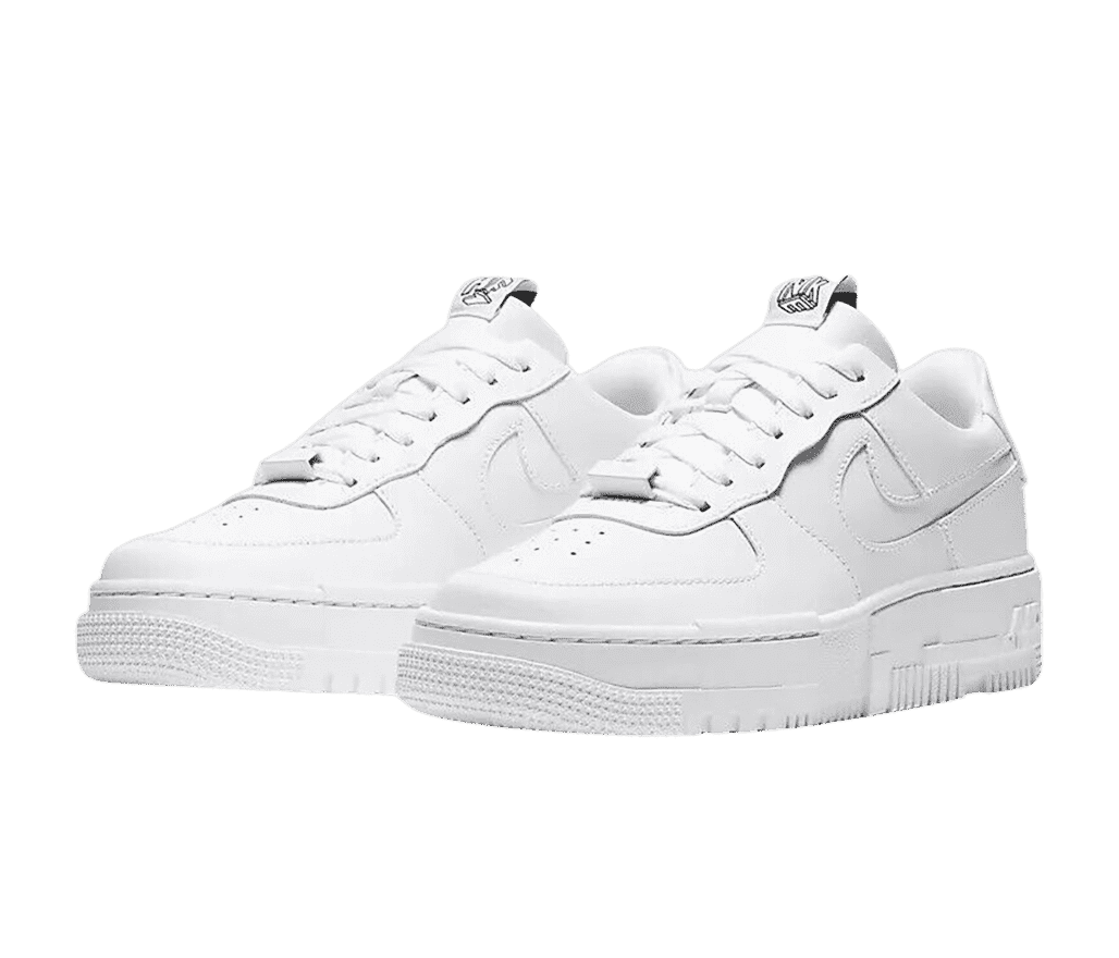 A pair of AF1 Low “Pixel” sneakers in all-white with staggered block patterns on the soles and a blank block lace tag.