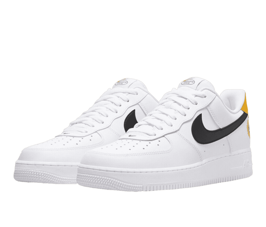 A pair of white Nike Air force 1s with a black swoosh and a bright yellow section on the top of the heel.