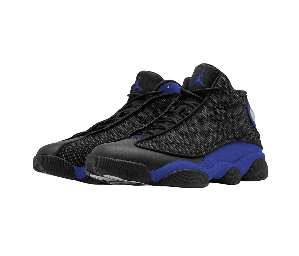 A black pair of AJ13 “Hyper Royal” sneakers with blue suede quarters, black leather toeboxes and outsoles, and white-dotted fabric vamps with circular embroidery.