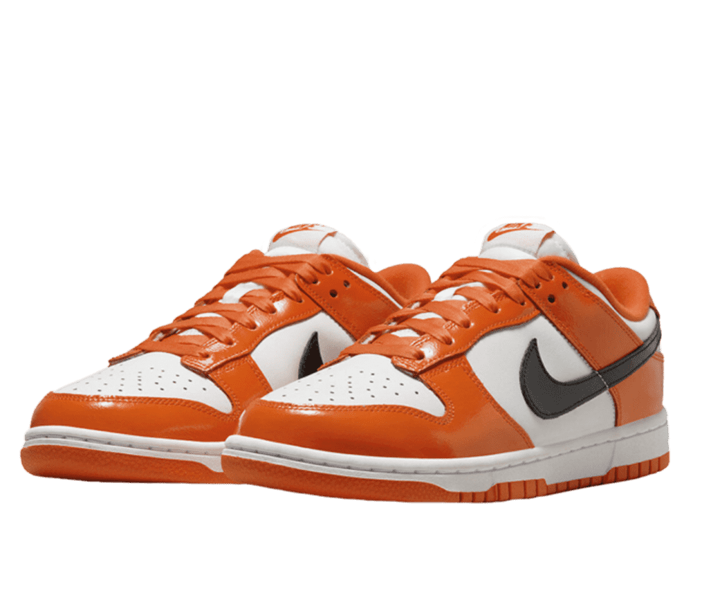 An angular, front view of a pair of Nike Dunk Low “Orange Black”. This colorway comes in a white base and midsole with a glossy orange overlay in a leather finish. The inner lining is a matching orange and the sides feature a black Nike swoosh.