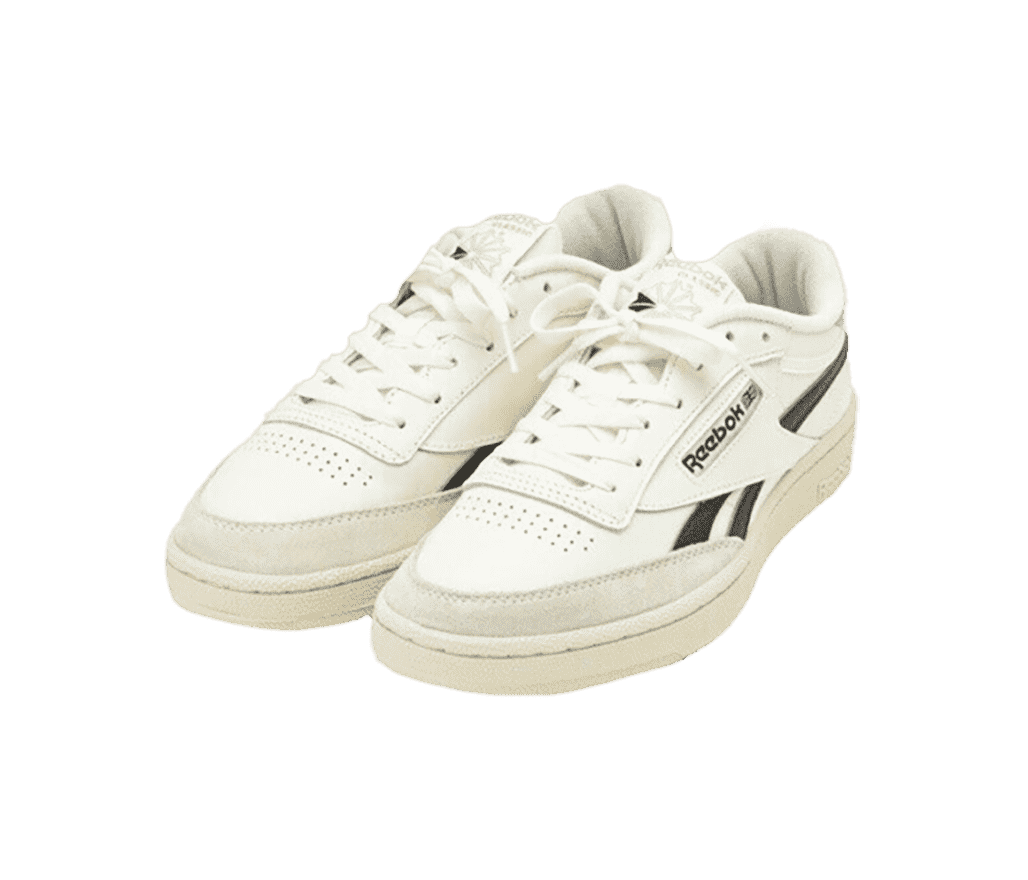 A pair of Reebok Classic “Revenge” sneakers in neutral off-white shades and charcoal Reebok stripes running across the sides.